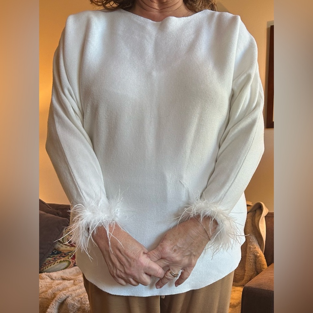 White knit sweater with feather cuffs